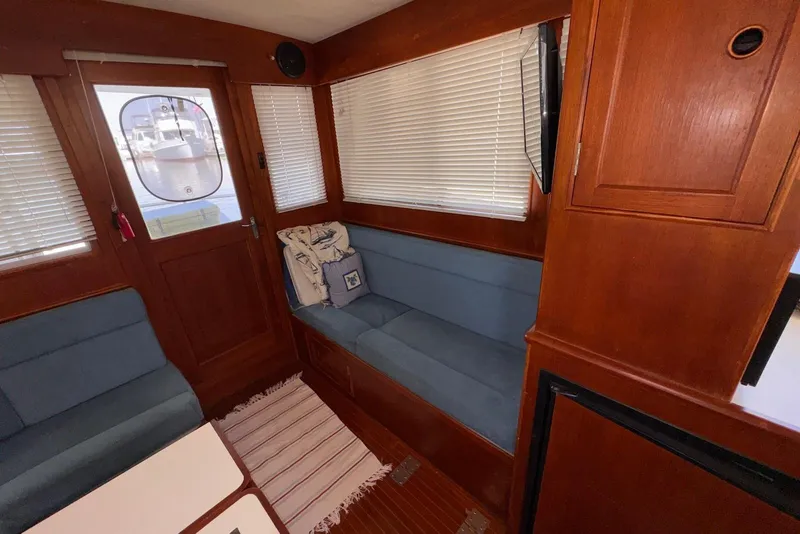 Slide: The Image of Interior of 1995 Island Gypsy Eurosedan 32 with wooden paneling and blue seating. - 28