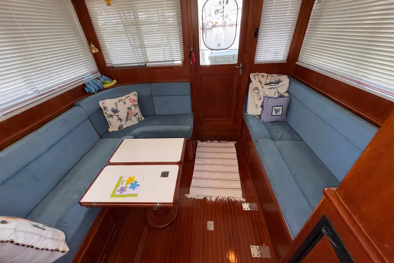 Slide: The Image of Interior of 1995 Island Gypsy Eurosedan 32 with blue seating and wooden accents. - 29