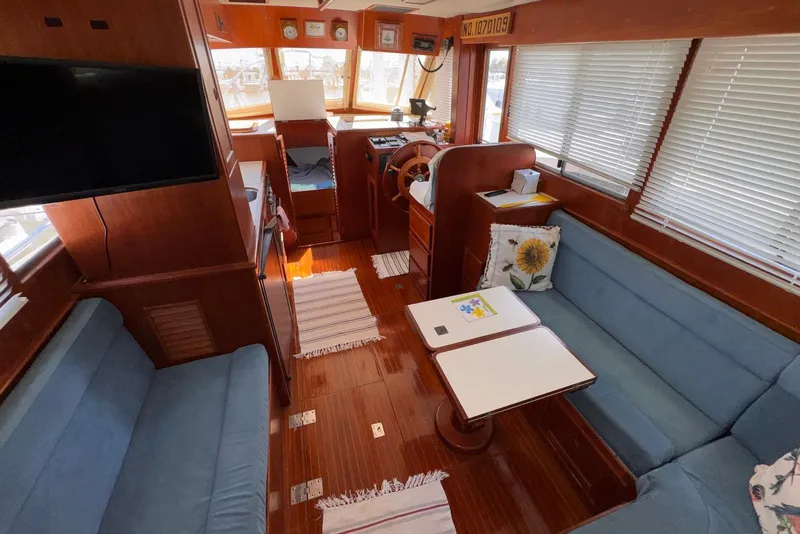 Slide: The Image of Interior of a 1995 Island Gypsy Eurosedan 32, featuring cozy seating and wooden finishes. - 30