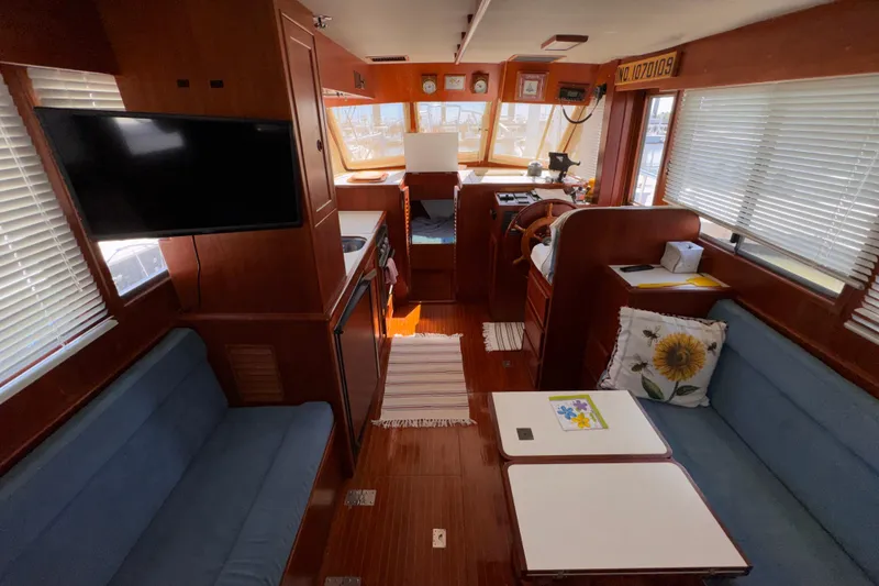 Slide: The Image of Interior of 1995 Island Gypsy Eurosedan 32 yacht with cozy seating and modern amenities. - 31