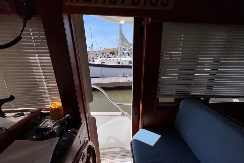 Slide: The Image of Interior view of 1995 Island Gypsy Eurosedan 32, showing marina through cabin door. - 35