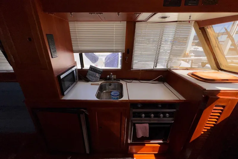 Slide: The Image of 1995 Island Gypsy Eurosedan 32 kitchen with sink, stove, and microwave. - 36