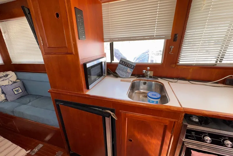 Slide: The Image of Interior of 1995 Island Gypsy Eurosedan 32 with kitchen and seating area. - 38