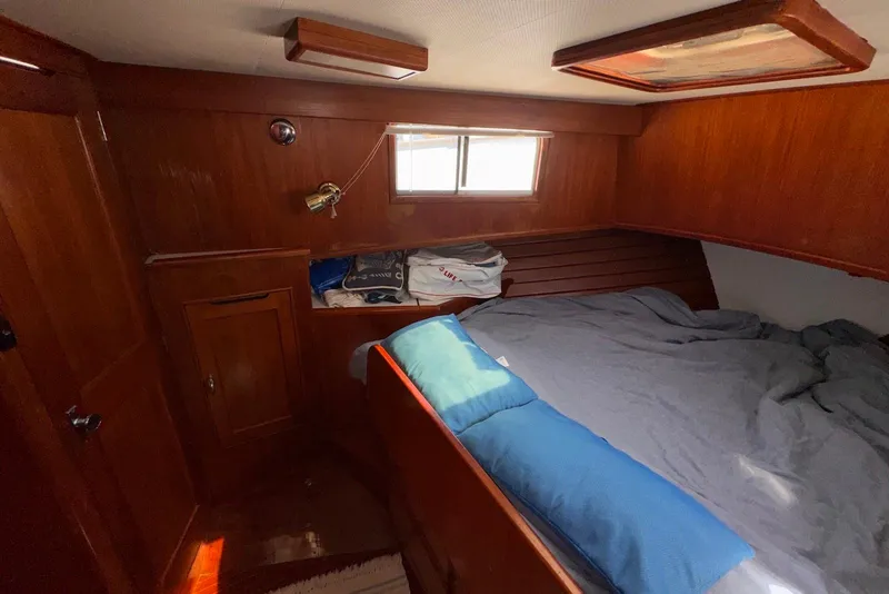 Slide: The Image of Cozy cabin interior of 1995 Island Gypsy Eurosedan 32 with wooden paneling and bed. - 40