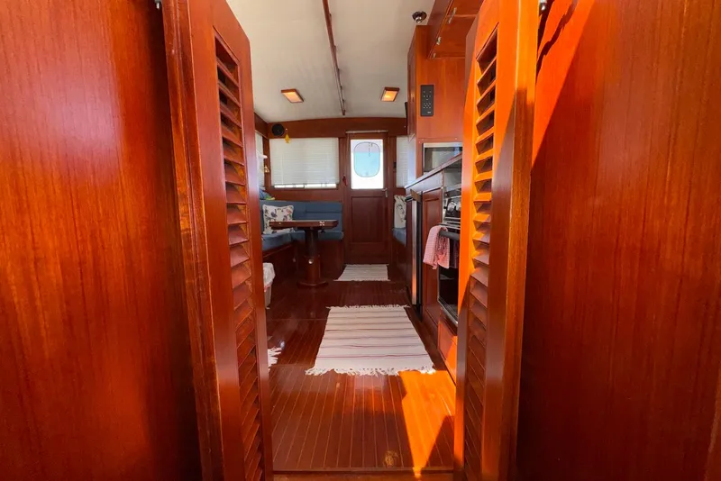 Slide: The Image of Interior of 1995 Island Gypsy Eurosedan 32, featuring wooden finishes and cozy seating area. - 41