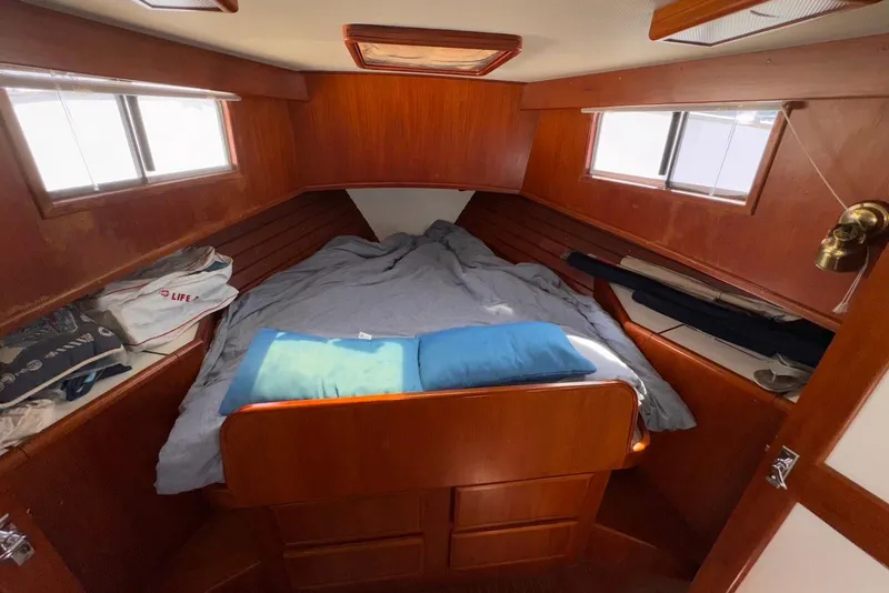 Slide: The Image of Cozy cabin interior of 1995 Island Gypsy Eurosedan 32 with wooden finish and bedding. - 42