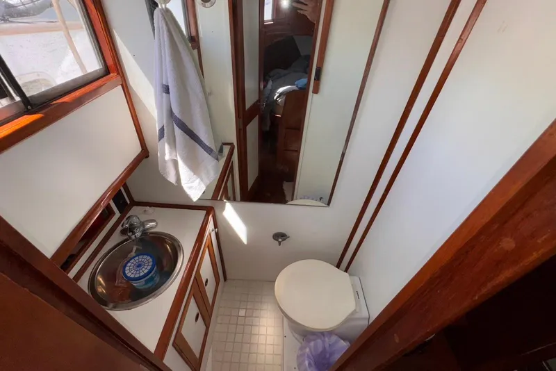 Slide: The Image of Bathroom interior of 1995 Island Gypsy Eurosedan 32 with sink, toilet, and towel. - 44