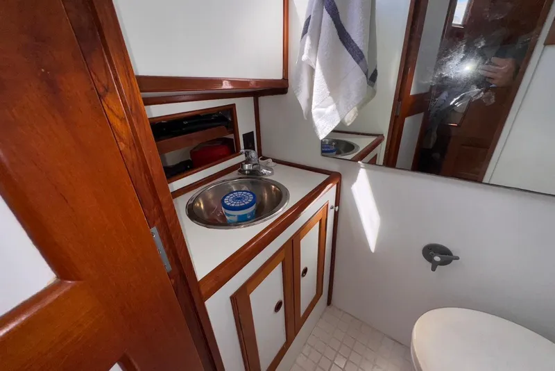 Slide: The Image of 1995 Island Gypsy Eurosedan 32 bathroom with wooden cabinetry and stainless steel sink. - 45