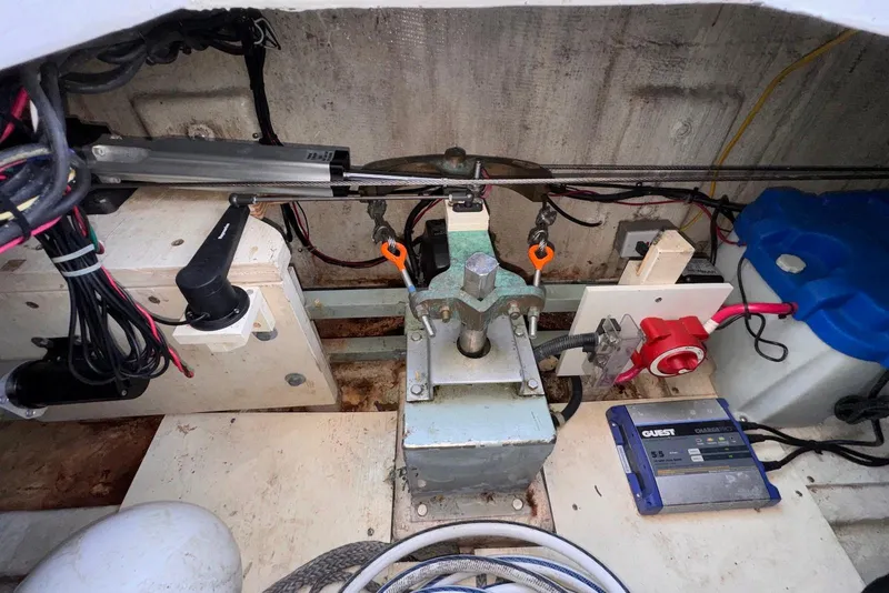 Slide: The Image of Engine compartment of a 1995 Island Gypsy Eurosedan 32 with mechanical components and wiring. - 47