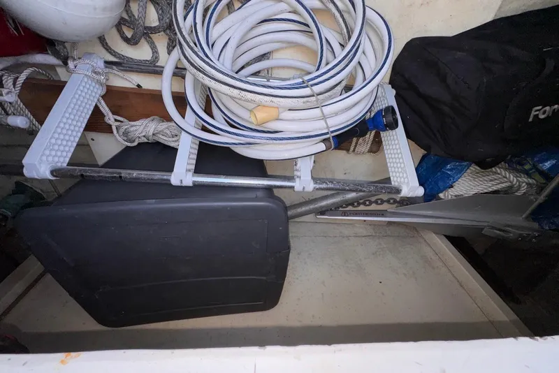 Slide: The Image of Storage compartment of a 1995 Island Gypsy Eurosedan 32 with coiled hose and equipment. - 49