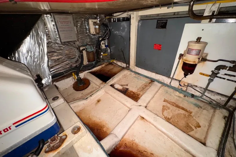 Slide: The Image of Engine room of a 1995 Island Gypsy Eurosedan 32, showing mechanical components and wiring. - 52