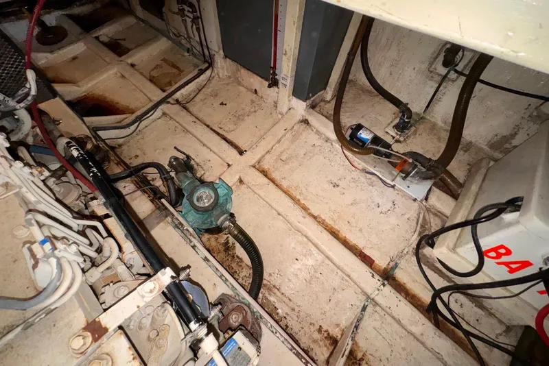 Slide: The Image of Engine room of a 1995 Island Gypsy Eurosedan 32, showing mechanical components and wiring. - 53