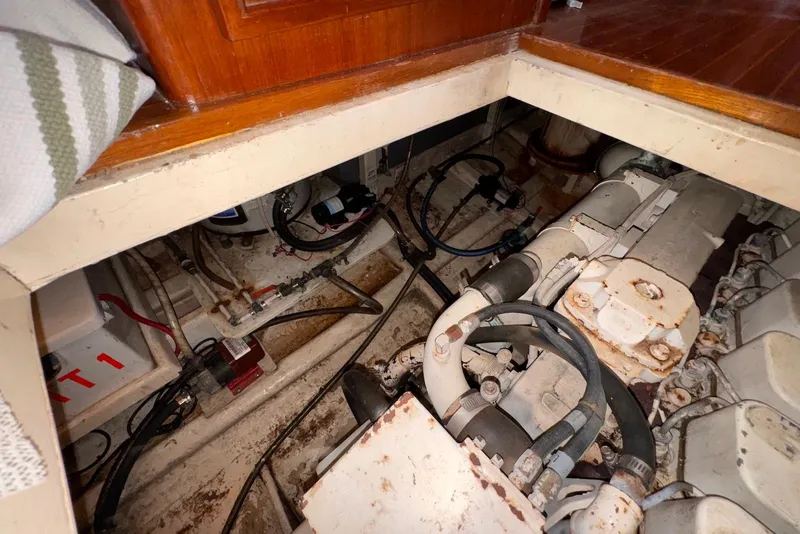 Slide: The Image of Engine room of a 1995 Island Gypsy Eurosedan 32, showing mechanical components and wiring. - 54