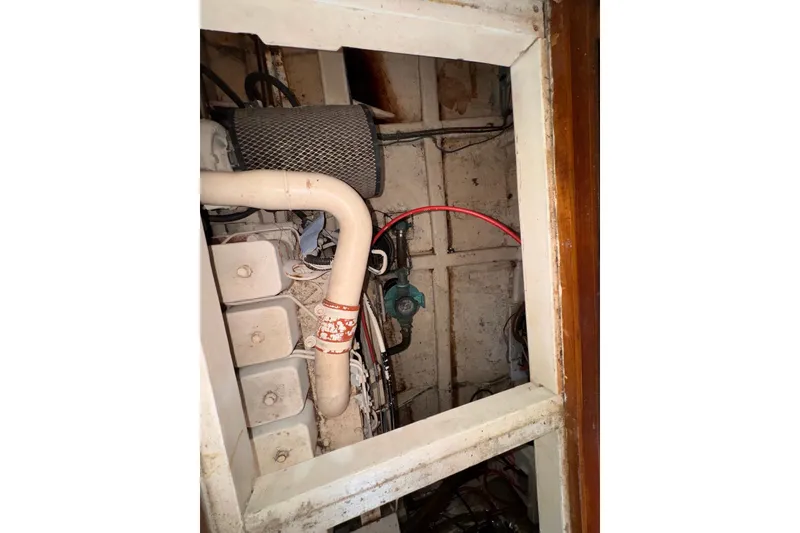 Slide: The Image of Engine compartment of a 1995 Island Gypsy Eurosedan 32 boat, showing mechanical components. - 56