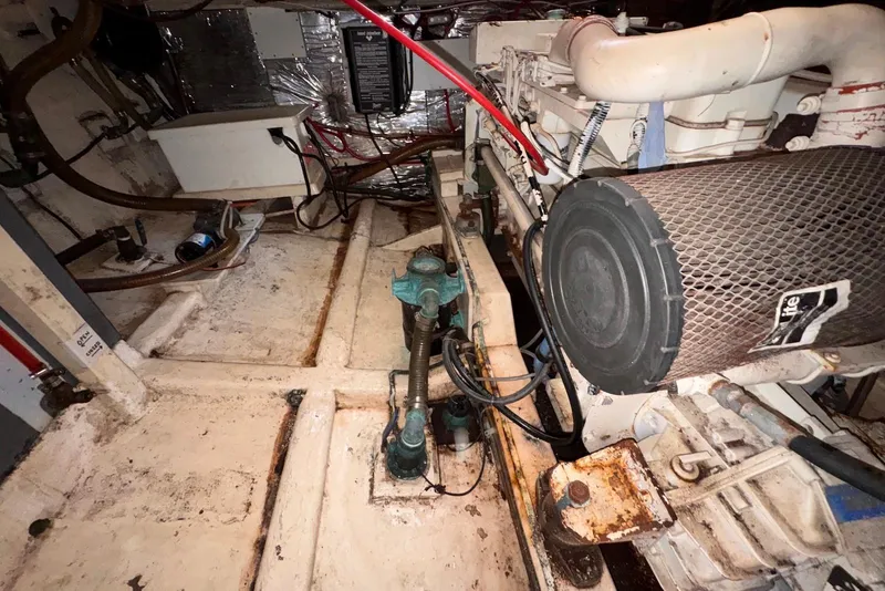 Slide: The Image of Engine room of a 1995 Island Gypsy Eurosedan 32, showcasing mechanical components and wiring. - 58