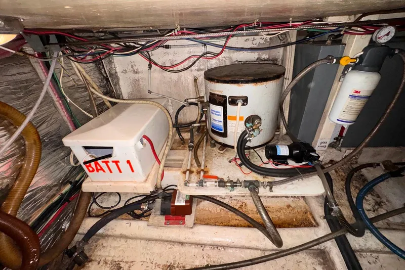 Slide: The Image of Engine room of a 1995 Island Gypsy Eurosedan 32 with battery and equipment. - 60