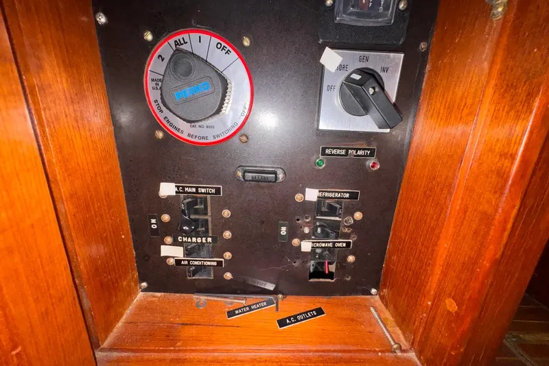 Slide: The Image of Control panel of a 1995 Island Gypsy Eurosedan 32 boat with switches and labels. - 64