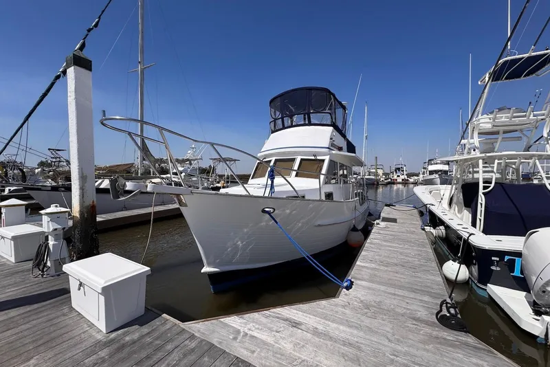 Slide: The Image of 1995 Island Gypsy Eurosedan 32 yacht docked at marina under clear blue sky. - 7