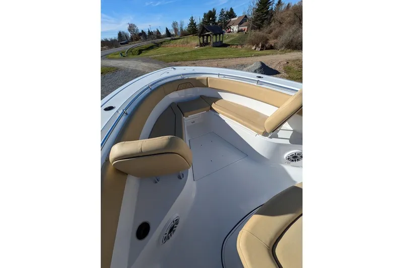 Slide: The Image of 2025 Sportsman Open 282 Center Console boat interior with tan seating and speakers. - 10