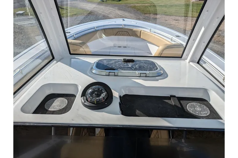 Slide: The Image of 2025 Sportsman Open 282 Center Console boat interior with compass and hatch. - 14