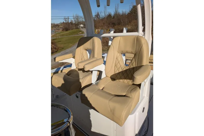 Slide: The Image of Beige leather seats on 2025 Sportsman Open 282 Center Console boat. - 15