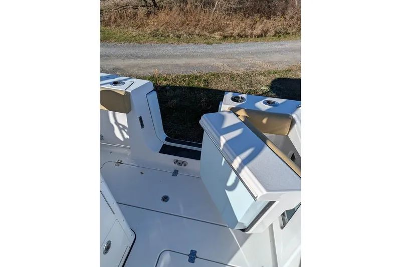 Slide: The Image of 2025 Sportsman Open 282 Center Console boat interior with seating and cup holders. - 17