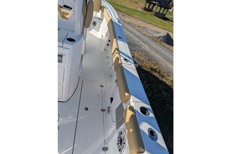 Slide: The Image of 2025 Sportsman Open 282 Center Console boat interior with tan seating and cup holders. - 18