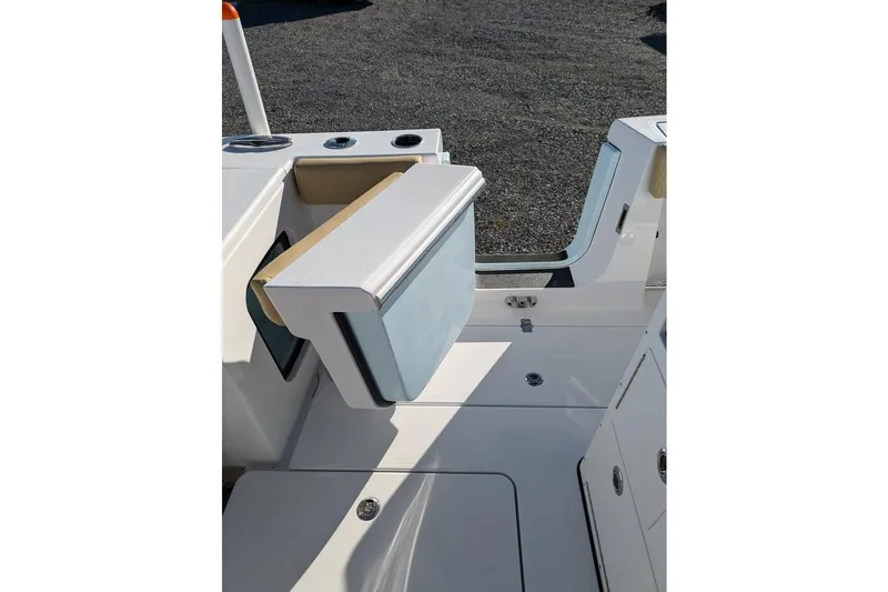 Slide: The Image of 2025 Sportsman Open 282 Center Console boat interior, featuring a foldable seat and storage area. - 19