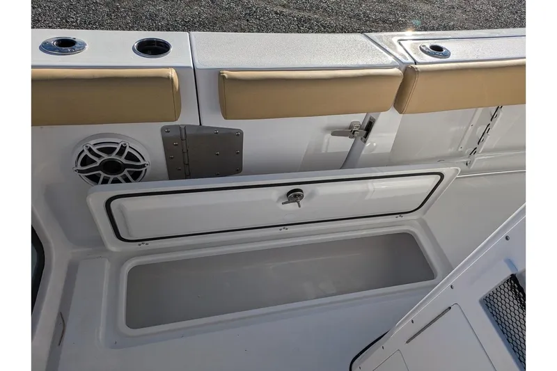Slide: The Image of 2025 Sportsman Open 282 Center Console boat interior with storage compartment and speaker. - 20
