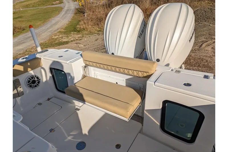 Slide: The Image of 2025 Sportsman Open 282 Center Console boat with dual engines and cushioned seating. - 23