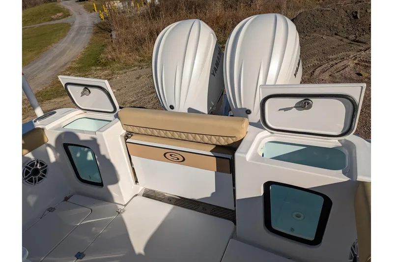 Slide: The Image of 2025 Sportsman Open 282 Center Console boat with dual Yamaha engines and storage compartments. - 24