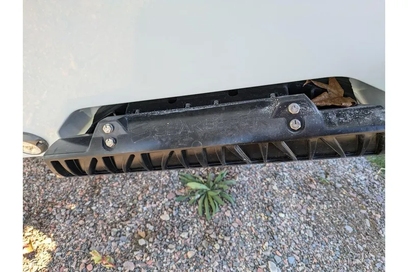 Slide: The Image of 2025 Sportsman Open 282 Center Console boat detail with black fin and bolts. - 25