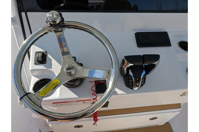 Slide: The Image of Steering wheel and controls of 2025 Sportsman Open 282 Center Console boat. - 3