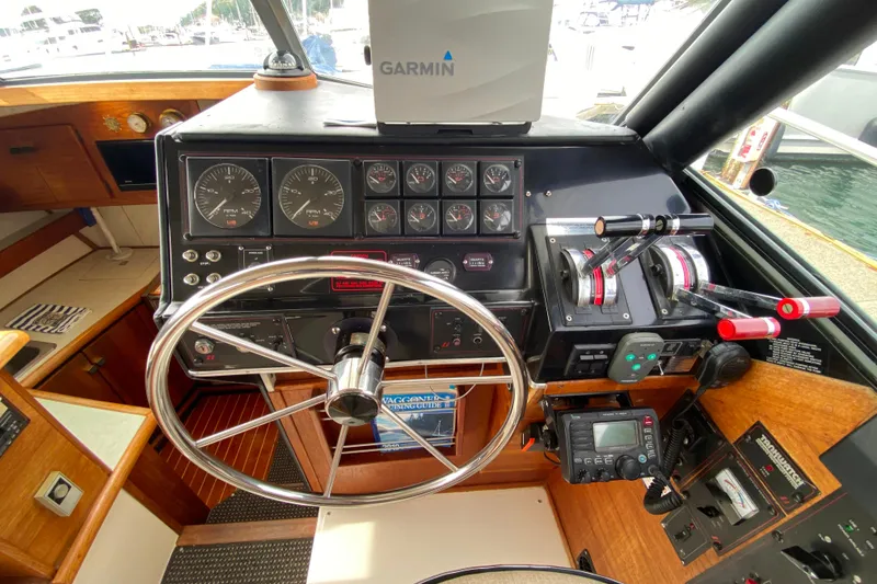 Slide: The Image of 1989 Bayliner 3288 Motoryacht helm with Garmin navigation, gauges, and controls. - 23