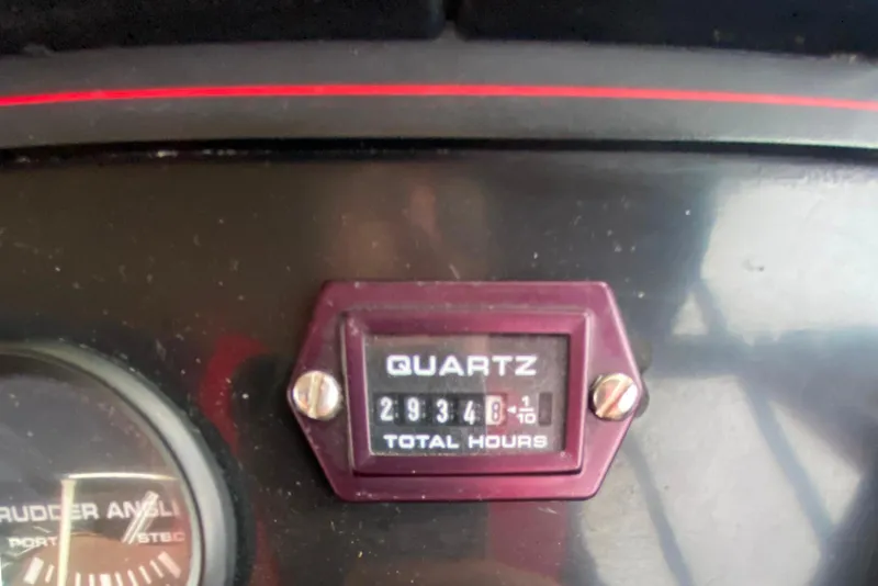 Slide: The Image of Instrument panel of 1989 Bayliner 3288 Motoryacht showing rudder angle and total hours. - 24