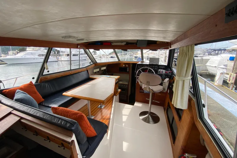 Slide: The Image of Interior of 1989 Bayliner 3288 Motoryacht with seating, table, and helm station. - 3