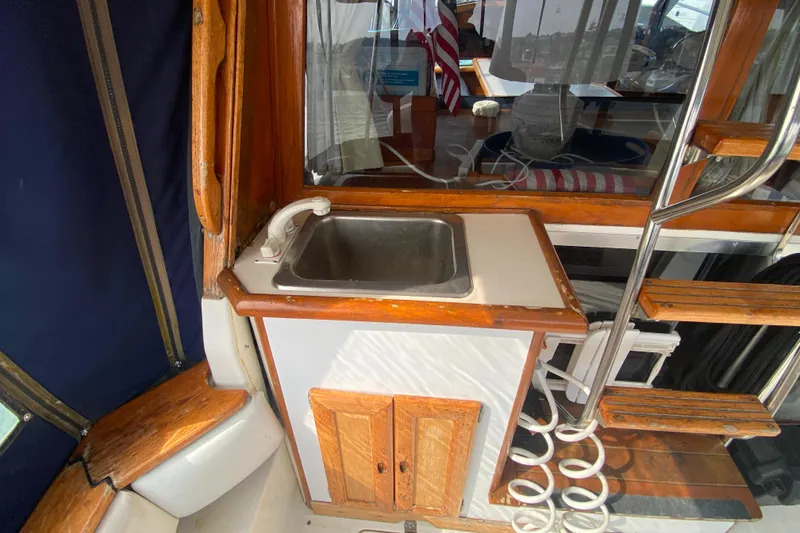 Slide: The Image of 1989 Bayliner 3288 Motoryacht interior with sink and wooden accents. - 32