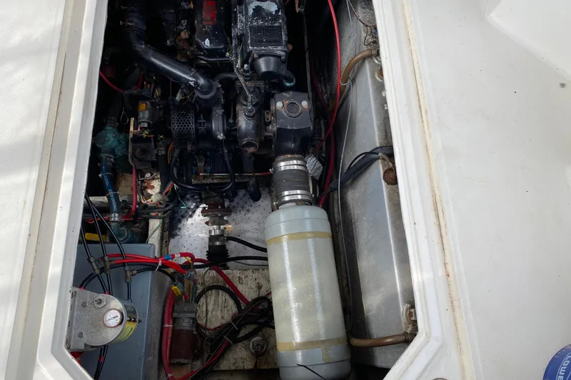 Slide: The Image of Engine compartment of a 1989 Bayliner 3288 Motoryacht, showcasing mechanical components and wiring. - 34