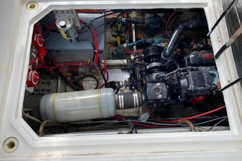 Slide: The Image of Engine compartment of a 1989 Bayliner 3288 Motoryacht, showcasing mechanical components and wiring. - 37