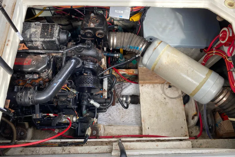 Slide: The Image of Engine compartment of a 1989 Bayliner 3288 Motoryacht, showcasing mechanical components and wiring. - 38