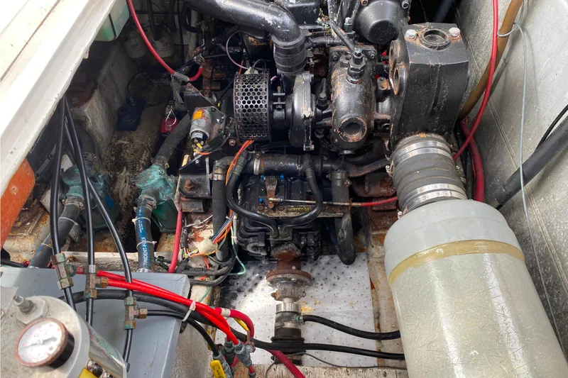 Slide: The Image of Engine compartment of a 1989 Bayliner 3288 Motoryacht, showcasing mechanical components and wiring. - 39