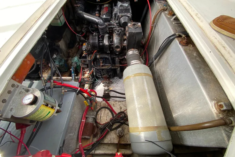 Slide: The Image of Engine compartment of 1989 Bayliner 3288 Motoryacht, showcasing mechanical components and wiring. - 40