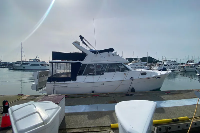 Slide: The Image of 1989 Bayliner 3288 Motoryacht docked at marina, surrounded by other boats. - 46