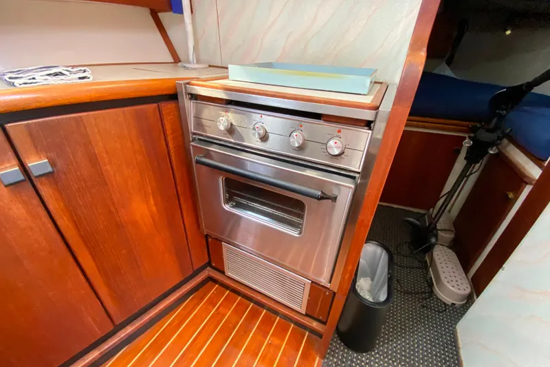Slide: The Image of 1989 Bayliner 3288 Motoryacht interior kitchen with stainless steel oven and wooden cabinetry. - 9
