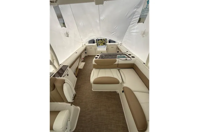 Slide: The Image of 2019 World Cat Glacier Bay Edition 2740 Dual Console interior with beige seating and white canopy. - 12