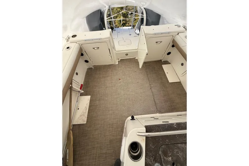 Slide: The Image of 2019 World Cat Glacier Bay Edition 2740 Dual Console boat interior with open storage compartments. - 14