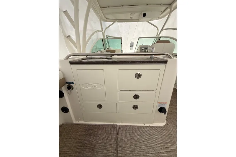 Slide: The Image of 2019 World Cat Glacier Bay Edition 2740 Dual Console interior with storage compartments. - 16