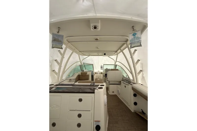 Slide: The Image of 2019 World Cat Glacier Bay Edition 2740 Dual Console interior view, featuring seating and storage. - 17
