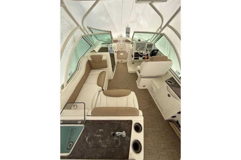 Slide: The Image of 2019 World Cat Glacier Bay Edition 2740 Dual Console interior with beige seating and helm. - 18