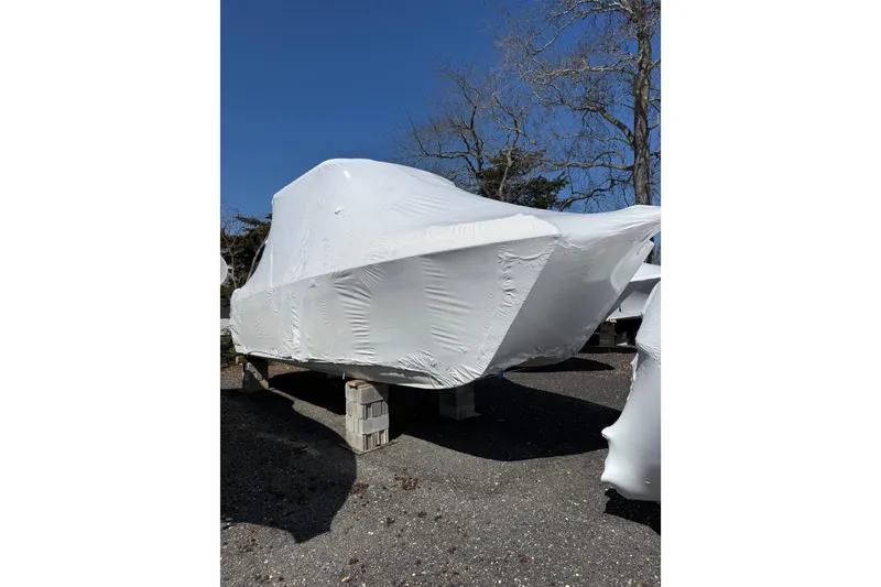 Slide: The Image of 2019 World Cat Glacier Bay Edition 2740 Dual Console boat covered in protective wrap. - 22